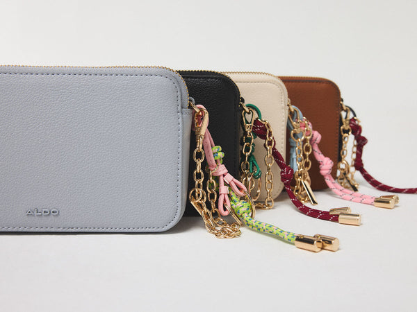 Cluster of colorful handbags with keychains.